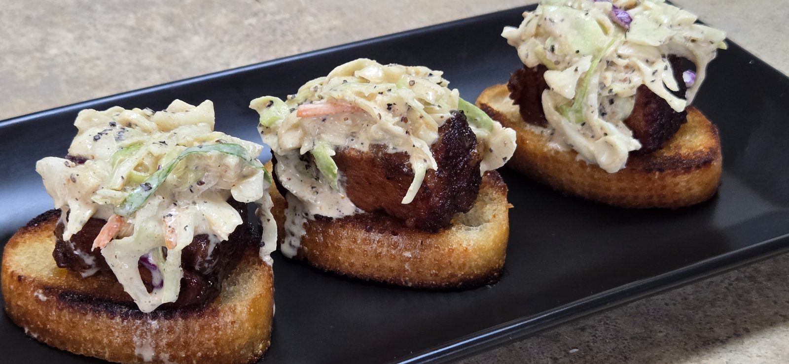 Pork belly burnt end crostini