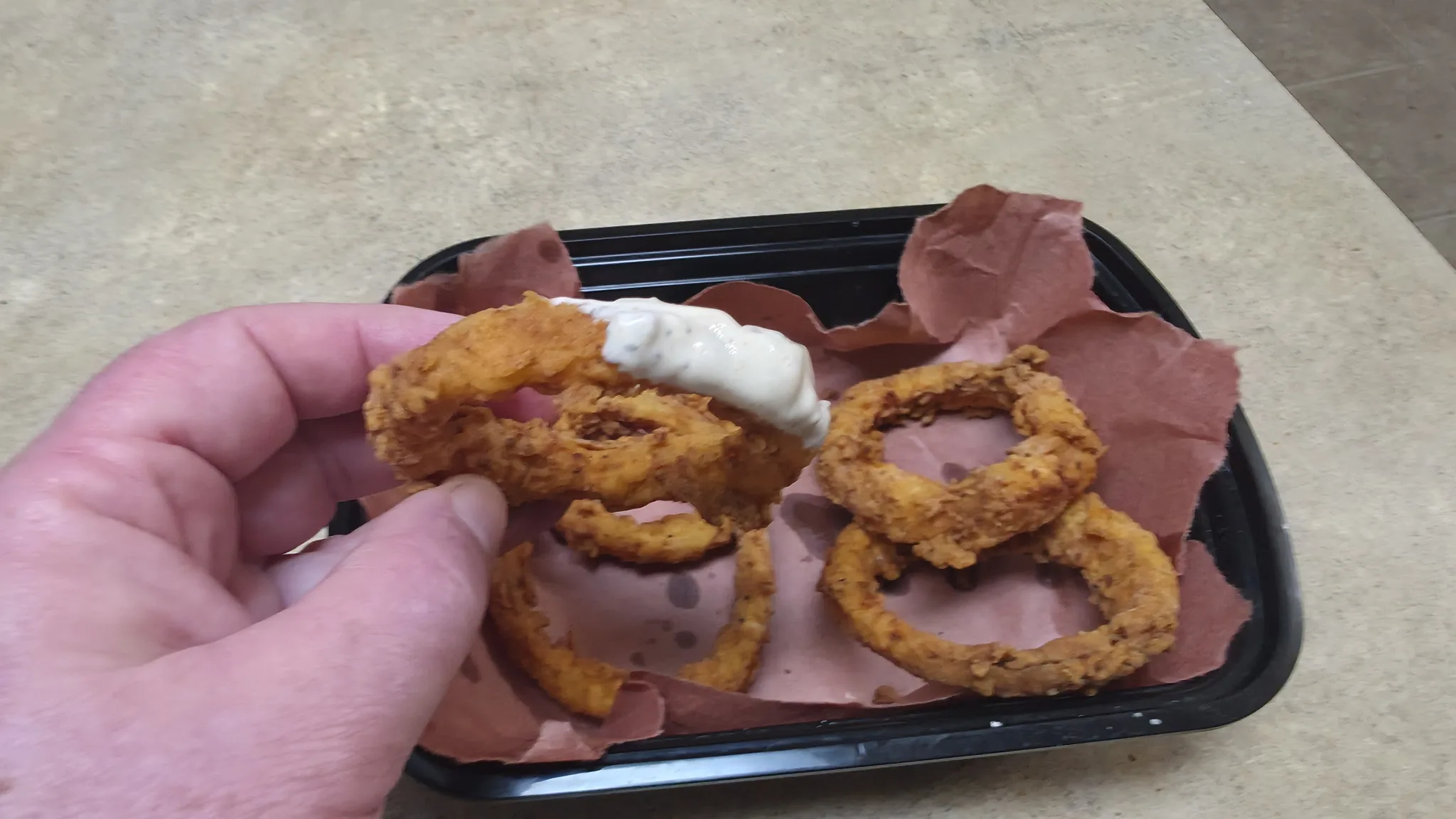 Extreme-heat onion ring dipped in creamy Inferno Dip